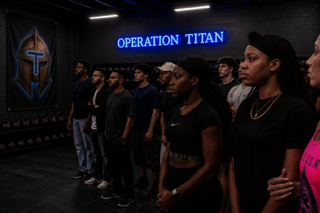 People standing in formation under Operation Titan sign